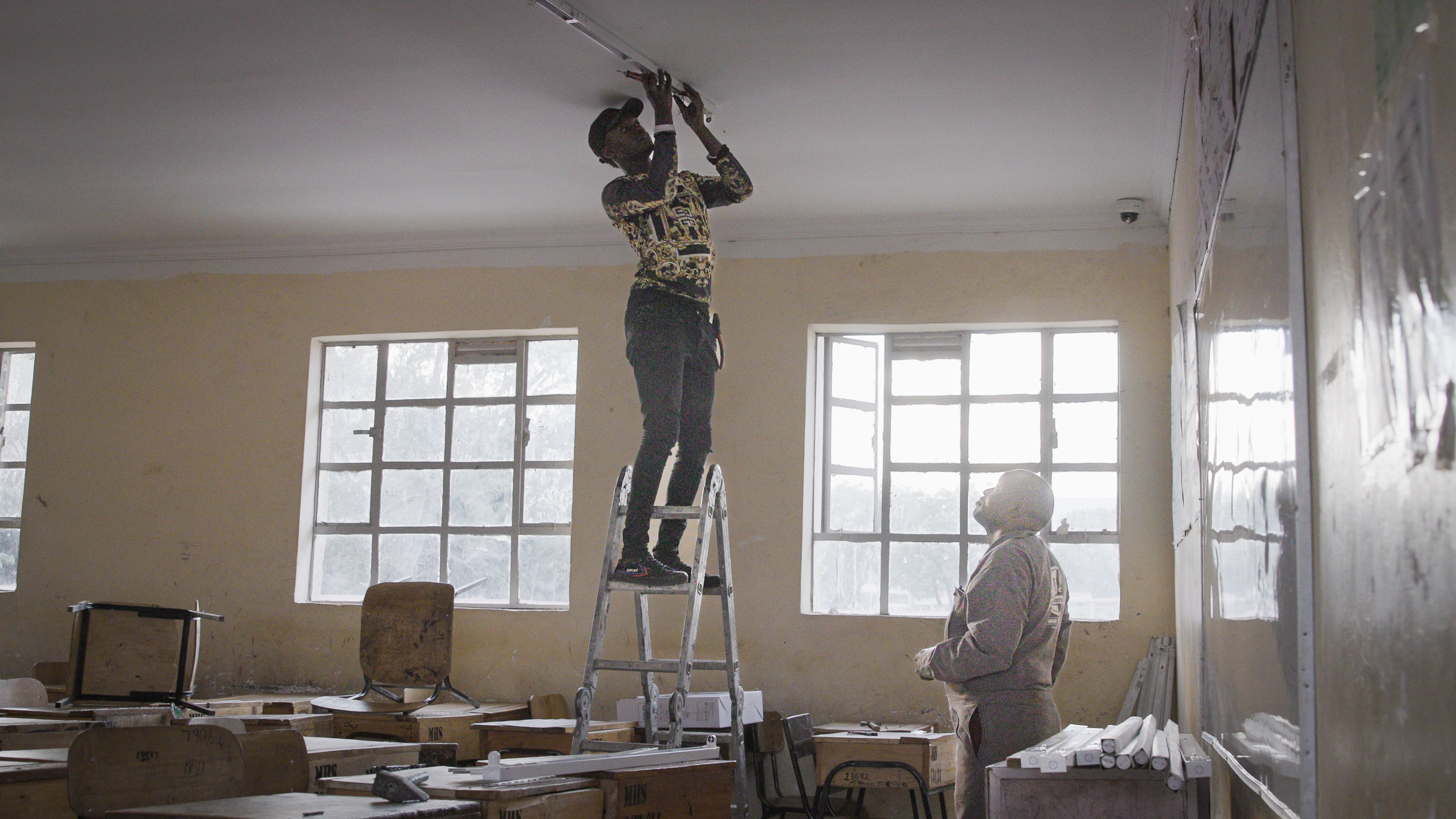 Workers install new high-efficiency LED lights at the Menengai boarding school in Nakuru, Kenya. Credit: UNEP/Eugene Kaiga