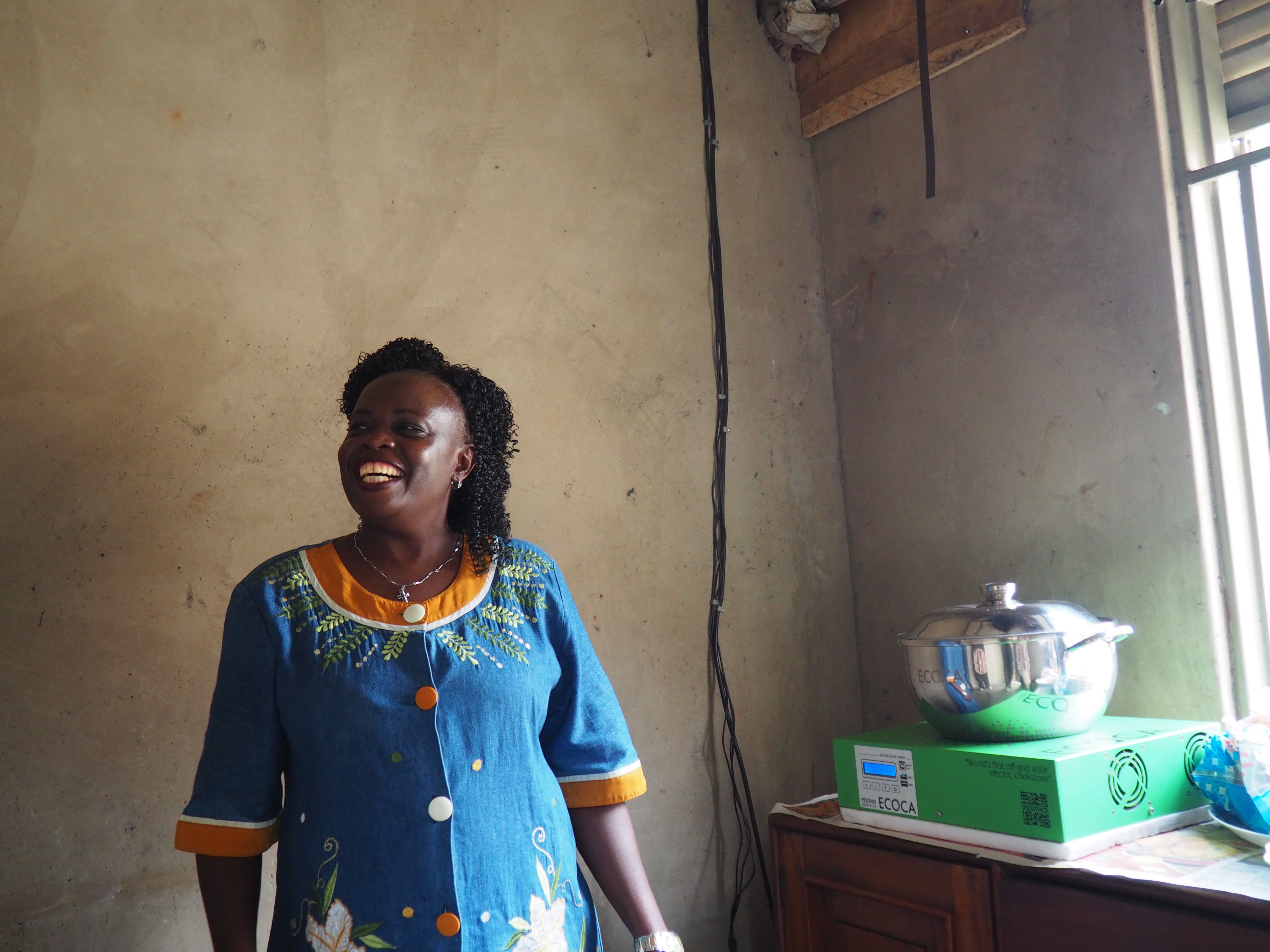 Christine Kagimu showing her e-cooker.